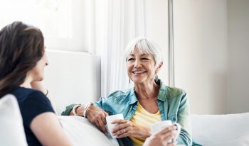 Happy women having tea together.