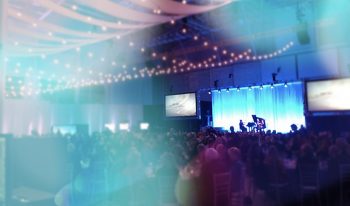 Full audience at a campaign event with piano feature