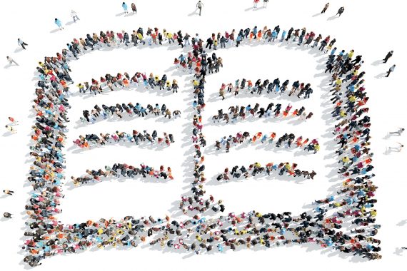 Aeral view of people standing in the shape of an open book.