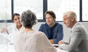 Four people in an informational meeting