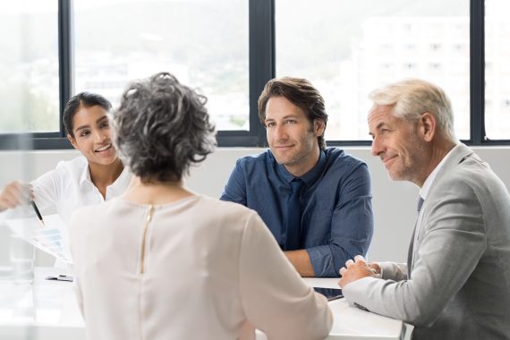 Four people in an informational meeting