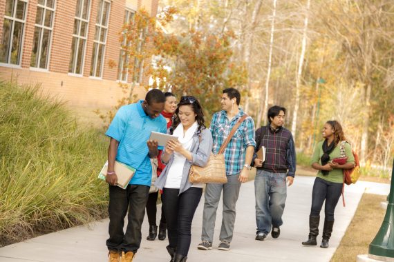 Students walking down the sidewalk and talking.