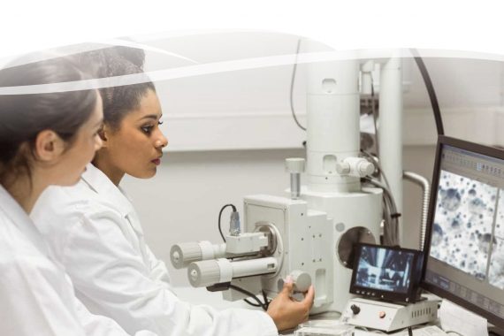 two research scientists looking at a microscopic computer