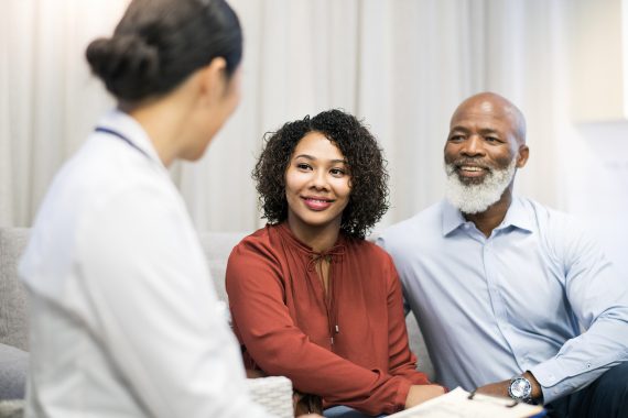 couple talking to professional in white shirt