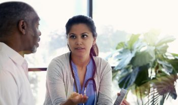 Clinician talking to a business professional