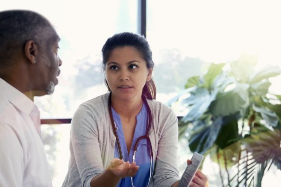 Clinician talking to a business professional