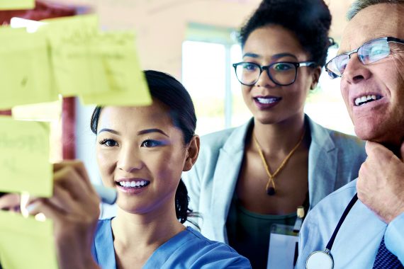 Medical professionals using sticky notes for brainstorming