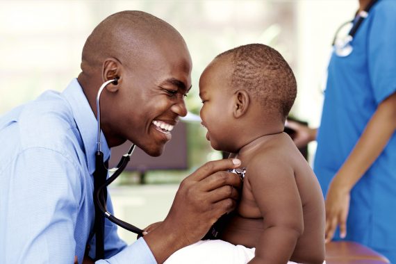 Clinician checking a small child's heart beat with a stethoscope