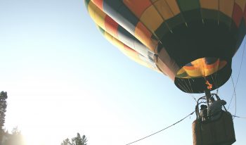 Multicolored hot air balloon tethered to the ground
