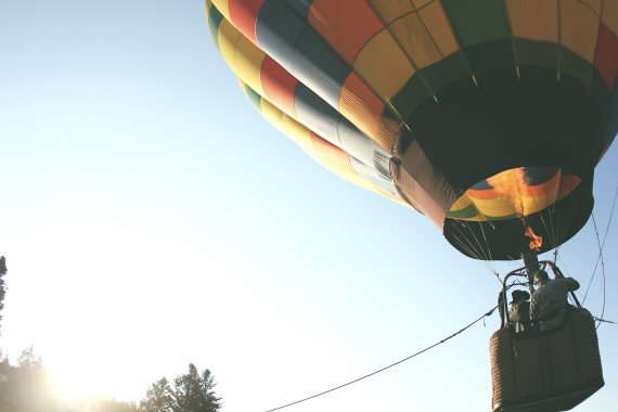 Multicolored hot air balloon tethered to the ground
