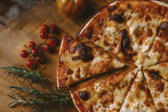 Pizza pie sliced to serve